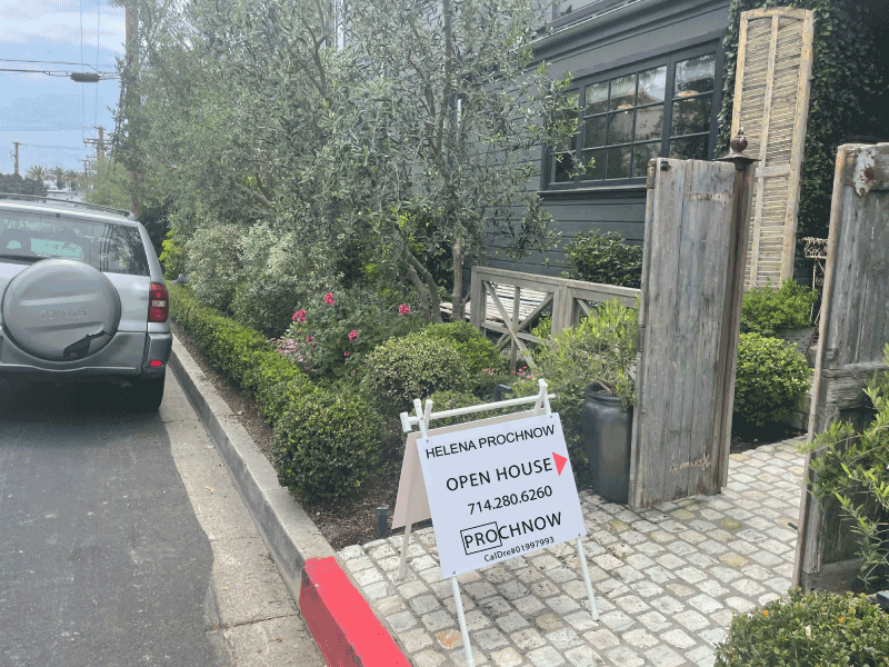 open house sign in front of a house with vintage gate in Corona Del Mar, CA neighborhood.